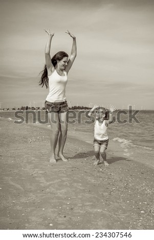 Happy family. Young beautiful  mother and her daughter having fun on the beach. Positive human emotions, feelings, joy.