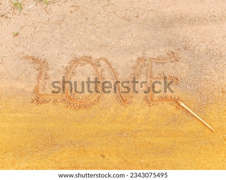 Yellow sand with the word love