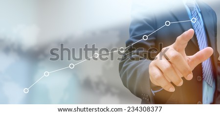 businessman hand pushing a business graph on a touch screen interface  Royalty-Free Stock Photo #234308377
