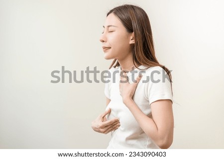 Acid reflux disease, suffer asian young woman have symptom gastroesophageal, esophageal, stomach ache and heartburn pain hand on chest from digestion problem after eat food, Healthcare medical concept Royalty-Free Stock Photo #2343090403
