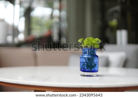 Flowers decorated in small vases on the table. It is a picture taken while relaxing at a hotel in Bangkok.