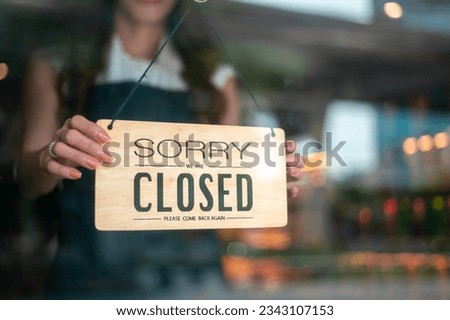 Woman entrepreneur with close sign in cafe shop , small business concept 