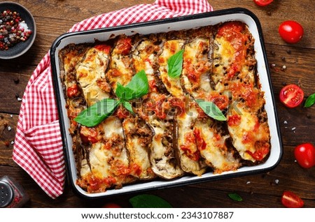Eggplant Casserole, Roasted Eggplant Dish with Minced Meat, Tomato Sauce and Mozzarella over Wooden Background