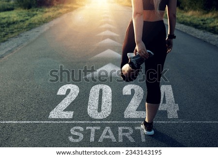  New Year 2024 with new ambitions, challenge, plans, goals and visions.Sports girl who wants to start the year 2024. Concept of new professional achievements in the new year and success. Royalty-Free Stock Photo #2343143195