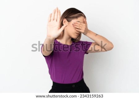 Young caucasian woman isolated on white background making stop gesture and covering face