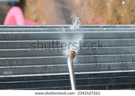 Closeup pictures of air conditioners accessories  cleaning with water high pressure.concept photo maintenance and repair electronics equipment and parts.