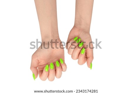 Hand of a woman with green naols hold some tiny or thin object, isolated on a white background.