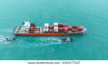Aerial top view of cargo ship carrying container and running with tug boat for import export goods from cargo yard port to custom ocean concept freight shipping by ship .