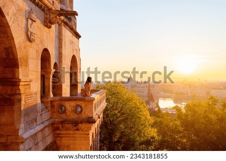 Beautiful caucasian woman enjoying morning view over Parliament in Budapest from Fisherman Bastion balcony Royalty-Free Stock Photo #2343181855