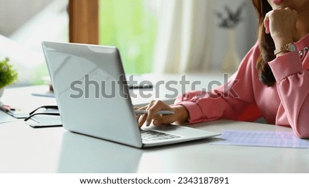 Cropped shot of female investment advisor chatting with client online, communicating on internet via laptop computer.