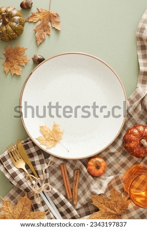 Heartwarming thanksgiving gathering idea. Top view photo of plate, cutlery, glass, tablecloth, autumnal decorations on olive background