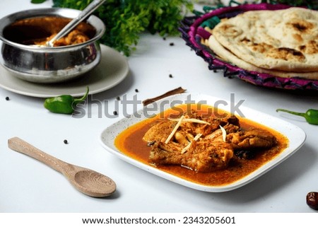 Delicious Chicken Korma indian - pakistani style with nan Royalty-Free Stock Photo #2343205601