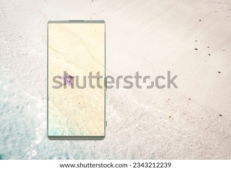 Clarity and vivid colors of the smartphone screen, Smartphone with the image of the starfish on the sand beach, right copy space for text, phone screen technology concept.