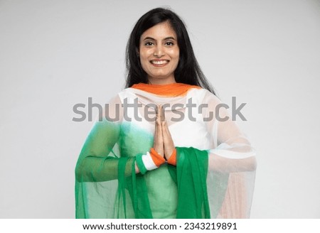 Indian happy beautiful women wear tricolor indian flag dupatta holding hands. Proud women looking in front of the camera. Indian Independence day, Indian Republic day concepts Royalty-Free Stock Photo #2343219891
