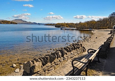 

Beautiful View from Luss one of the many picturesque villages on with pleasure boat in distance on Loch Lomond in Scotland u.k. Royalty-Free Stock Photo #2343237113