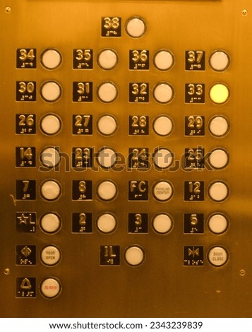 Classic iconic American highrise brass tone elevator button panel with braille markings. High quality photo