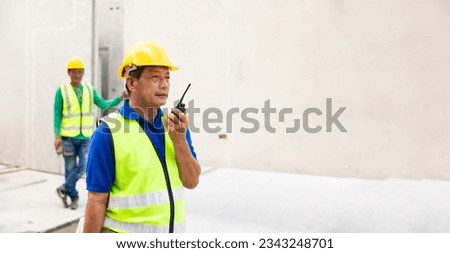 Radio walkie talkie. Asian senior man professional engineering working at precast concrete wall factory. Engineering worker in safety hardhat at factory industrial facilities. Prefabricated concrete 