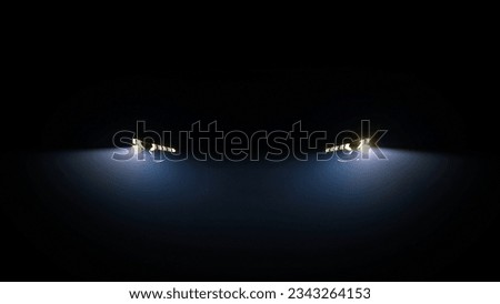 Car headlight blinking in Dark. Sports car Headlight. Switching of car LED headlights in night Royalty-Free Stock Photo #2343264153