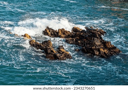 Blue beach rocks with waves