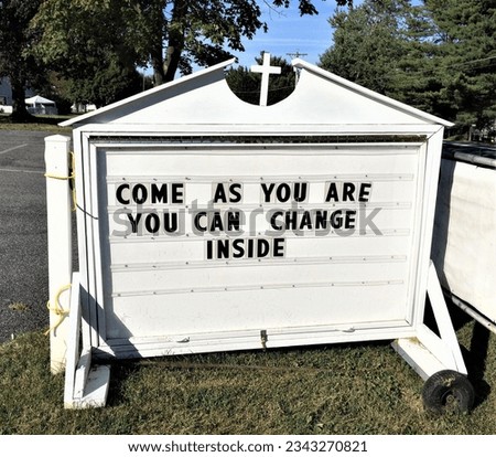 Below the cross on a church's welcome sign are the words COME AS YOU ARE YOU CAN CHANGE INSIDE.