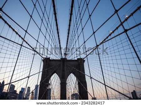 Capture the majestic allure of the Brooklyn Bridge, an architectural marvel spanning the East River in New York City. Witness the beauty of urban engineering in this stunning stock photo.