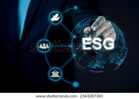 Businessman using stylus pen and virtual screen global with ESG icon concept against dark background.
