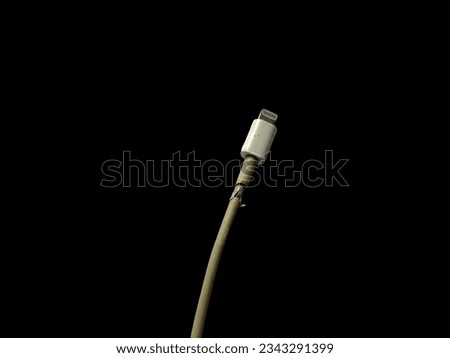 Broken iphone charger cable. Mobile phone charging cable that is broken but can still be used.Broken charging cable. Royalty-Free Stock Photo #2343291399