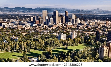 Denver Colorado skyline from the air, with Cheesman park in the forground, the flatirons in the background