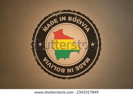 Brown paper with in its middle a retro style stamp Made in Bolivia include the map and flag of Bolivia.