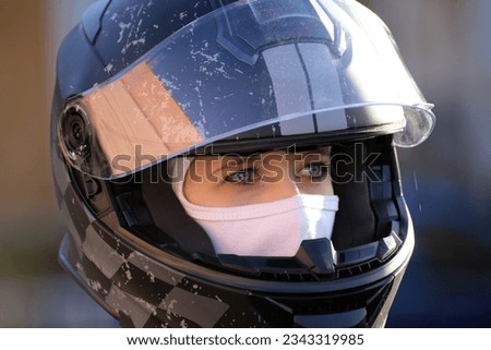 Symbol image: Female race car driver wears helmet and balaclava (Model released) Royalty-Free Stock Photo #2343319985