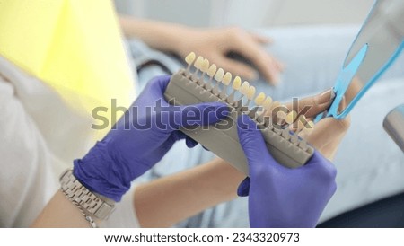 Young female dentist. Appointment to the orthodontist. Replacement of ceramic teeth. Polishing and whitening of teeth. The work of a dentist Royalty-Free Stock Photo #2343320973