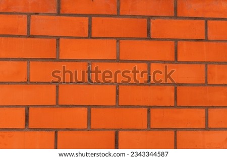 Brown wall made of cement and concrete and bricks. Rough surface. Urban architecture.