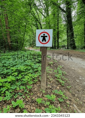 no trespassing sign at a way in the forest 