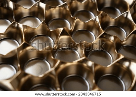 Abstract object of golden color consisting of round cells with sharp corners