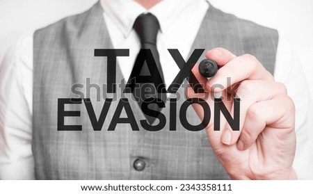 TAX EVASION words made with marker and hand
