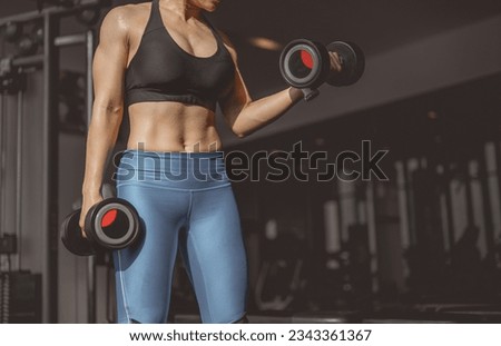 Concepts healthy lifestyle and workout. Bodybuilder, Workout, Fitness muscular body, Fitness, Gym. Fitness asian woman doing exercise and lifting dumbbells weights, bodyweight at sport gym  Royalty-Free Stock Photo #2343361367