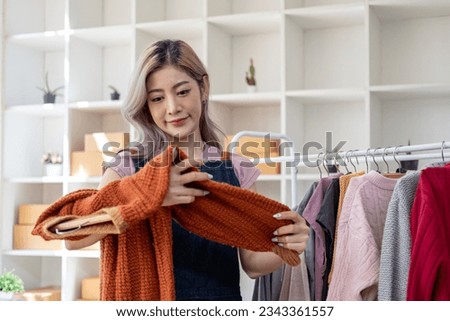 Young happy female woman lady fashion blogger business owner sale showing check clothes for present and sell in livestream live online internet shop 
