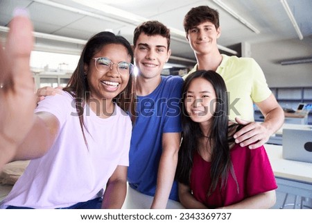 Selfie Portrait of a group of students in class looking at the camera. Young people of different ethnicities posing for a photo in the classroom. Back to school. High quality photo