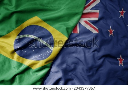 big waving realistic national colorful flag of brazil and national flag of new zealand . macro