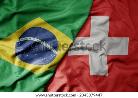 big waving realistic national colorful flag of brazil and national flag of switzerland . macro