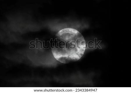 Halloween full moon in pitch black dark skies with clouds