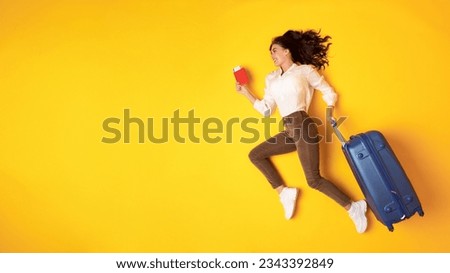 Travel Getaway. Happy Traveler Young Lady Running With Suticase And Boarding Pass Looking Aside At Blank Space, Promoting Cheap Tickets Offer On Yellow Background. Hurry Up For Vacation. Panorama