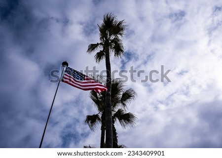 American flag under the clouds.