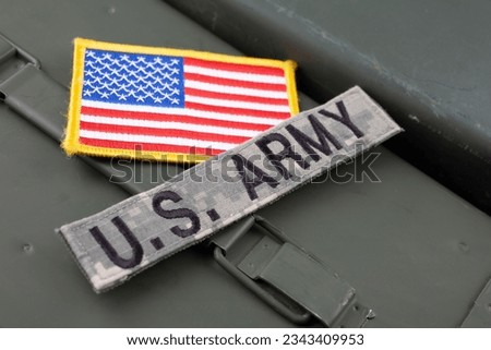 US ARMY Branch Tape with national US flag patch on green ammo can background