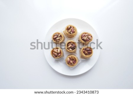 arabic dessert baklava on a plate on white background  Royalty-Free Stock Photo #2343410873