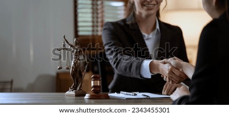 Businesswoman shaking hands to make a deal with her partner lawyers or attorneys discussing a contract agreement. Royalty-Free Stock Photo #2343455301