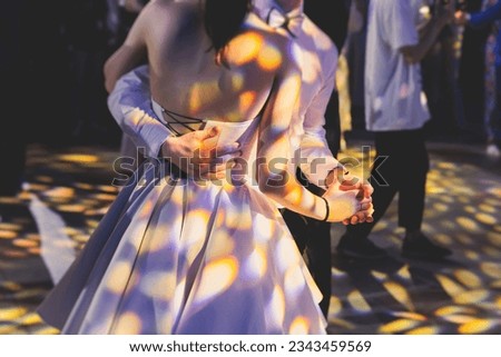 High school graduates dancing waltz and classical ball dance in dresses and suits on school prom graduation, classical ballroom dancers dancing, waltz, couples quadrille and polonaise Royalty-Free Stock Photo #2343459569