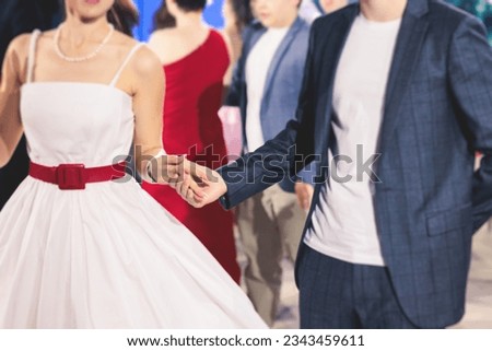High school graduates dancing waltz and classical ball dance in dresses and suits on school prom graduation, classical ballroom dancers dancing, waltz, couples quadrille and polonaise Royalty-Free Stock Photo #2343459611