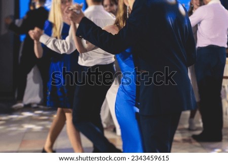 High school graduates dancing waltz and classical ball dance in dresses and suits on school prom graduation, classical ballroom dancers dancing, waltz, couples quadrille and polonaise Royalty-Free Stock Photo #2343459615