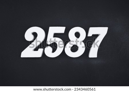 Black for the background. The number 2587 is made of white painted wood.